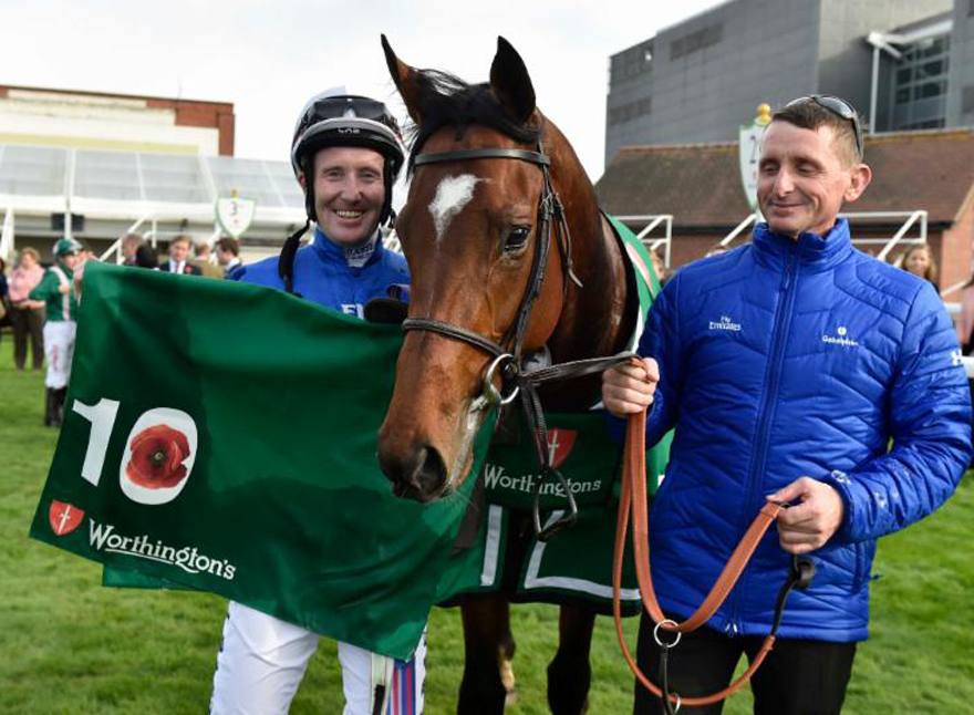 Best Solution, winner of the G3 Worthington's "Indigo Leisure" Stakes, & jockey Pat Cosgrave with the special Poppy saddle cloth marking the 10th anniversary of Newbury's Armed Forces Raceday (Photo courtesy Newbury Racecourse) 